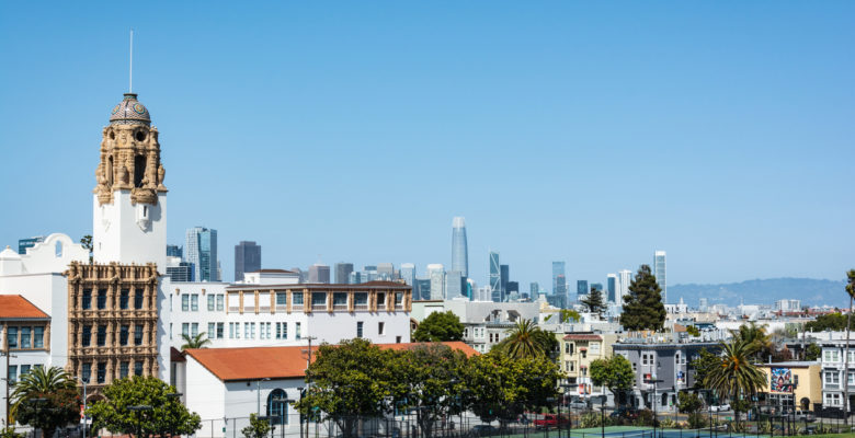 Mission Dolores Basilica and San Francisco skyline view from Dolores Park, California