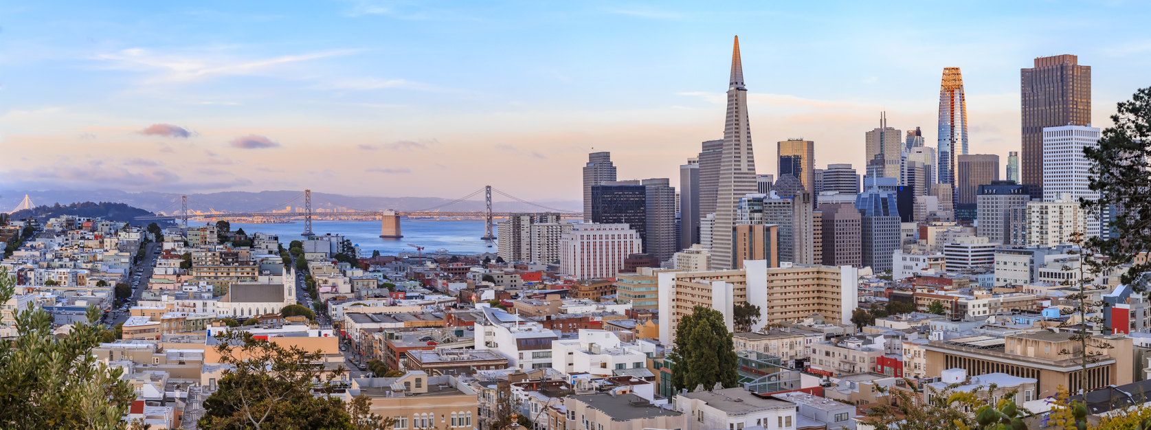 San Francisco skyline panorama at sunset with Bay Bridge and downtown skyline