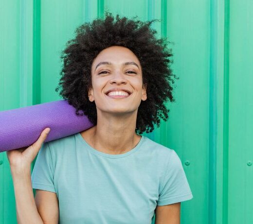 woman holding yoga mat