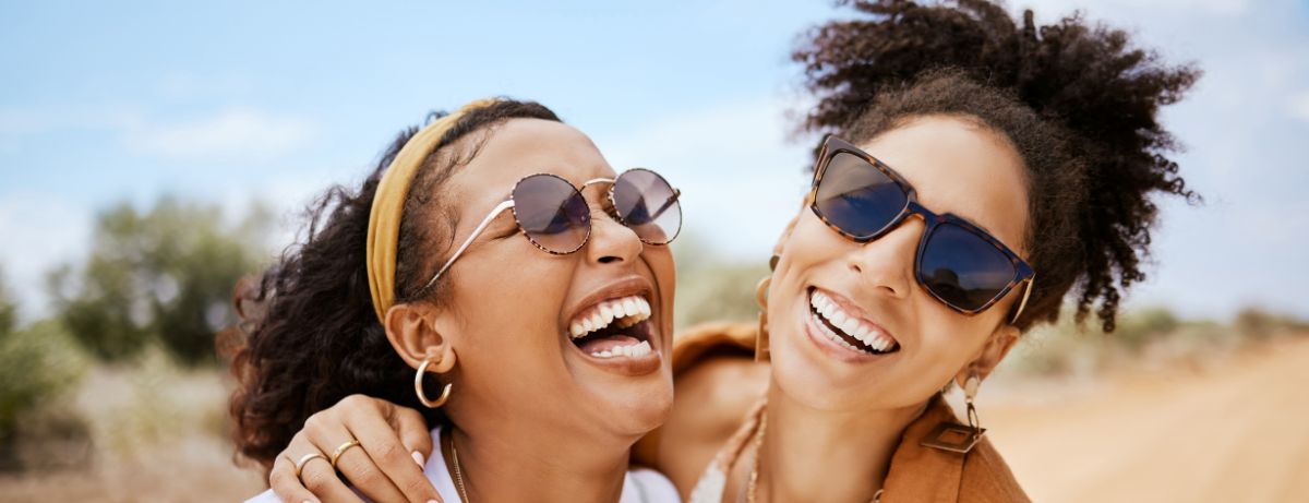 2 girls laughing and hugging