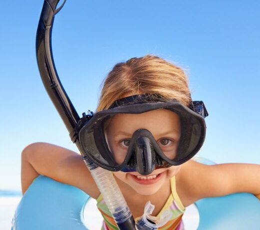 kid in innertube and snorkel