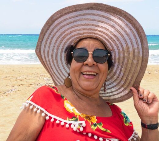 older woman in sunhat at beach